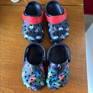 Set of two Crocs Kids' Multicolor Clogs. Size 5 for rockets and 6 for Dino’s.